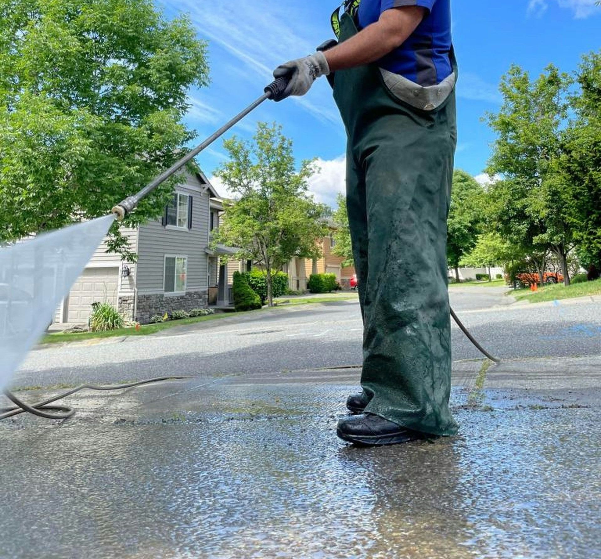 a man is cleaning the street with a hose